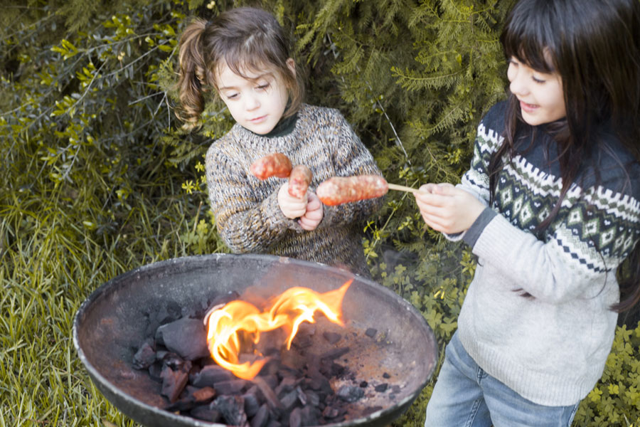 two-girls-burning-sausages